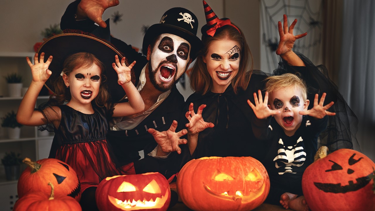 Imag of a mom, dad, daughter and son decked out in Halloween costumes posing for a picture - 3 bedroom apartments in lafyette la