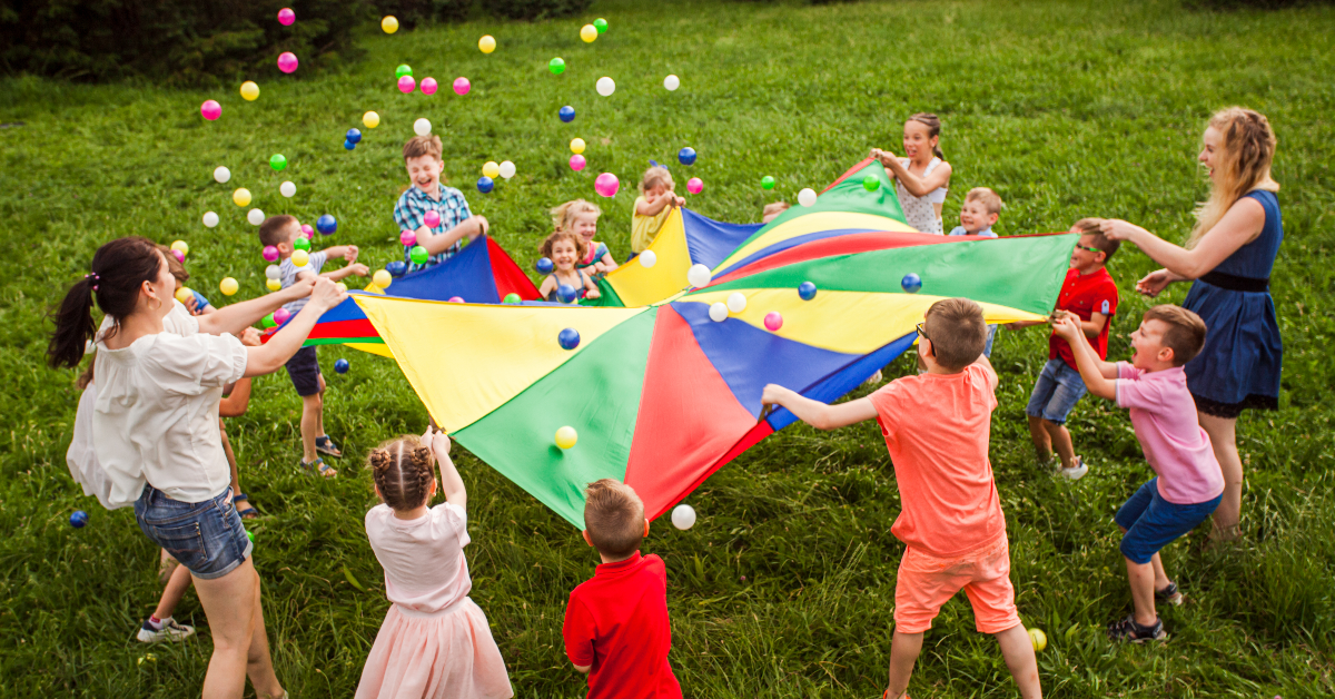 Children engaged in ball tossing activities- Lafayette Gardens Apartments - For Rent Lafayette La